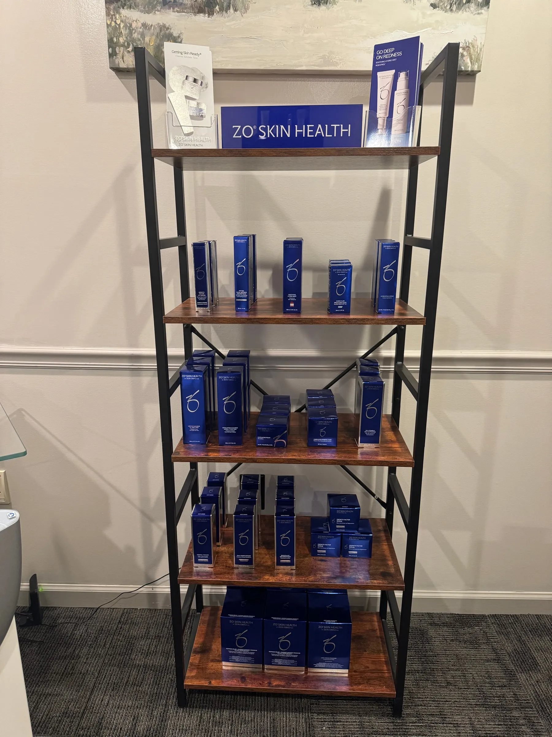 In-clinic display shelf stocked with ZO Skin Health medical-grade skincare products